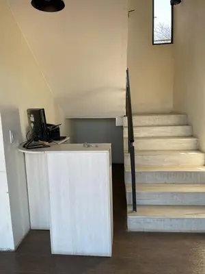 a room with stairs and a desk with a computer at Dinastie Country in Villa Rumipal