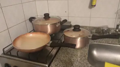 two pots and pans sitting on top of a stove at Departamento en Nueva Córdoba in Cordoba