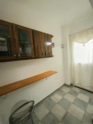 a kitchen with wooden cabinets and a chair in a room at CELESTINA in Cordoba