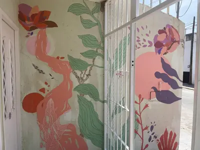 a wall with a mural of flowers on it at CELESTINA in Cordoba