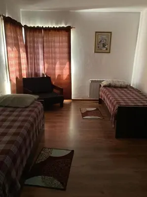 a hotel room with two beds and a couch at Casa con vista a las sierras de Cordoba in Malagueño
