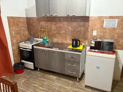 a small kitchen with a sink and a stove at Departamento Genaro in Mina Clavero