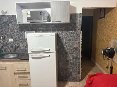 a white refrigerator in a kitchen with a microwave at Departamento Genaro in Mina Clavero