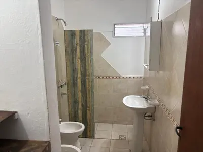 a small bathroom with a toilet and a sink at Departamento Genaro in Mina Clavero