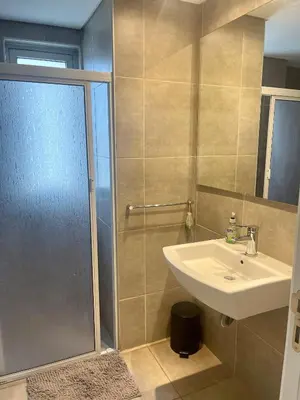 a bathroom with a shower and a sink and a showerspective at Rent a Flat - Río Cuarto in Río Cuarto