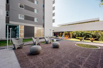 a courtyard with chairs and a building at Rent a Flat - Río Cuarto in Río Cuarto