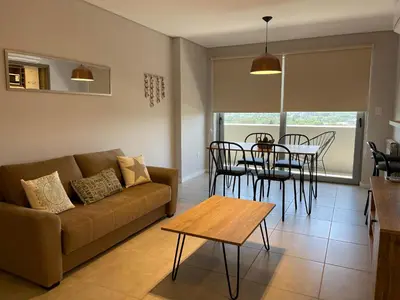 a living room with a couch and a table and chairs at Rent a Flat - Río Cuarto in Río Cuarto