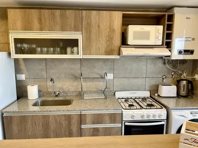 a kitchen with a sink and a stove top oven at Rent a Flat - Río Cuarto in Río Cuarto