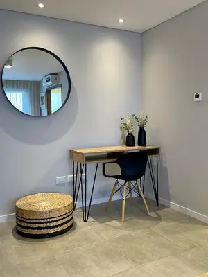 a table and a chair in a room with a mirror at Rent a Flat - Río Cuarto in Río Cuarto