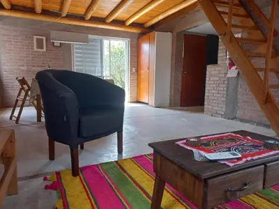 a living room with a chair and a coffee table at Posada del Paraíso-Exclusivo adultos in Las Rabonas