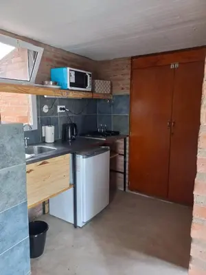 a small kitchen with a sink and a microwave at Posada del Paraíso-Exclusivo adultos in Las Rabonas