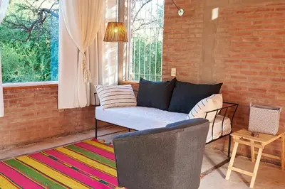a living room with a couch and a window at Posada del Paraíso-Exclusivo adultos in Las Rabonas