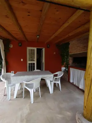 a large white table and chairs on a patio at Cabañas Paraje Noviembre in Nono