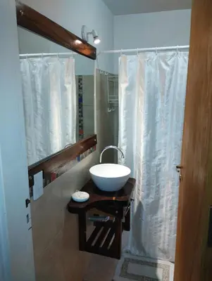 a bathroom with a bowl sink and a shower at Cabañas Paraje Noviembre in Nono