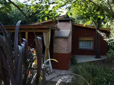 a small red building with a small window at Cabañas Paraje Noviembre in Nono