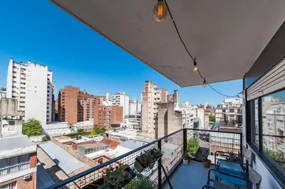 a balcony with chairs and a view of a city at Entre Ríos 73 - B Centro in Cordoba