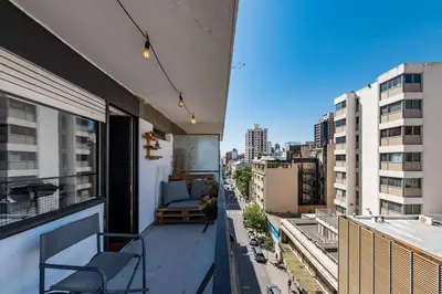 a balcony with a couch and a view of a city at Entre Ríos 73 - B Centro in Cordoba