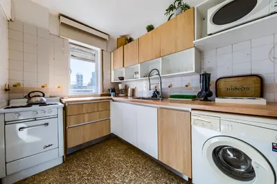 a kitchen with a washer and dryer in it at Entre Ríos 73 - B Centro in Cordoba