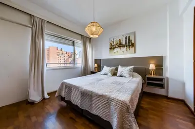 a bedroom with a bed and a large window at Entre Ríos 73 - B Centro in Cordoba
