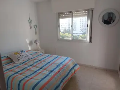 a bedroom with a bed and a window and a mirror at Departamento nuevo en Cordoba in Cordoba