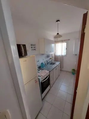 a small kitchen with a refrigerator and a sink at Departamento nuevo en Cordoba in Cordoba