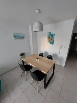 a dining room with a wooden table and chairs at Departamento nuevo en Cordoba in Cordoba