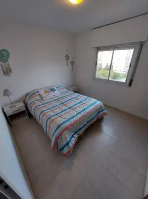 a bed in a white room with a window at Departamento nuevo en Cordoba in Cordoba