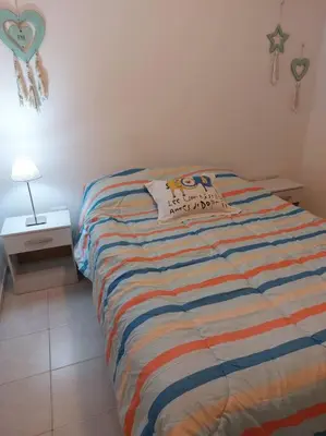 a bedroom with a bed with a pillow on it at Departamento nuevo en Cordoba in Cordoba