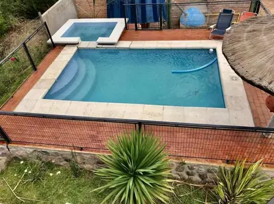 a large swimming pool in a backyard with a table and a table at LA MILAGROS ZORZAL COLORADO in Merlo