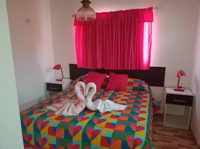 two swans towels on a bed in a bedroom at LA MILAGROS ZORZAL COLORADO in Merlo