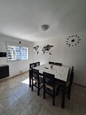 a dining room with a table and chairs at Departamento W R T 1 in Villa Carlos Paz