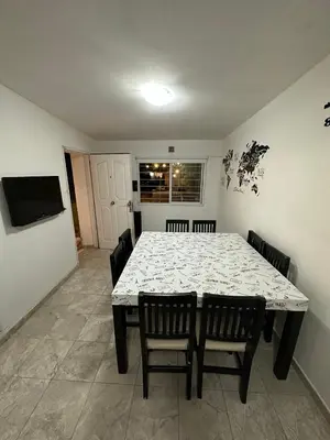 a dining room with a table and chairs and a television at Departamento W R T 1 in Villa Carlos Paz