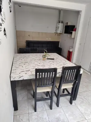 a dining room table with two chairs and a table and chairs at Departamento W R T 1 in Villa Carlos Paz