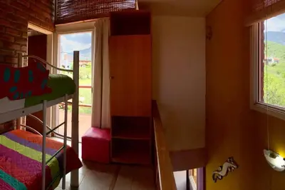 a room with a bunk bed and a stair case at CABAÑA LA MILAGROS REINA MORA in Merlo