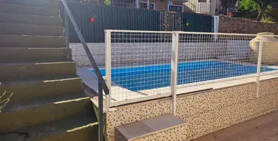 a tennis court behind a tennis net on some stairs at LUSANYUN in Villa Carlos Paz