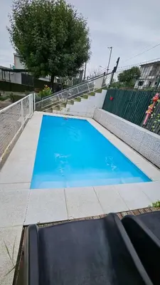 a large blue swimming pool next to some stairs at LUSANYUN in Villa Carlos Paz