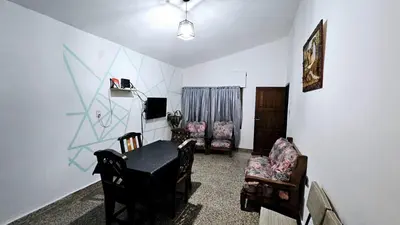 a living room with a table and two chairs at LUSANYUN in Villa Carlos Paz