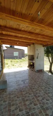 a patio with a wooden ceiling and a stone floor at Cabaña Nerviomotor in Cordoba