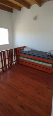 a bedroom with two bunk beds in a room with wooden floors at Cabaña Nerviomotor in Cordoba