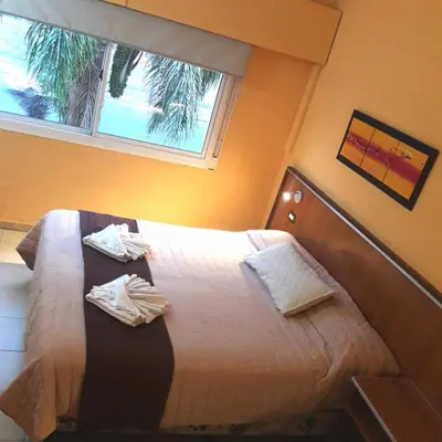 a bedroom with a bed with two towels on it at Saint Tropez Hotel in Villa Carlos Paz