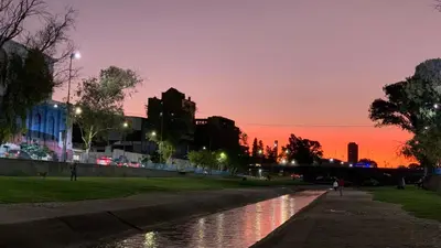 a sunset over a river in a city at Encantador Duplex cerca de todo in Cordoba