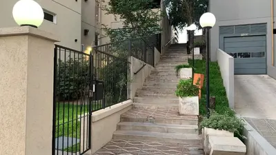 a set of stairs leading up to a house with a gate at Encantador Duplex cerca de todo in Cordoba