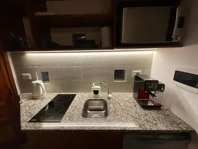a kitchen counter with a sink and a coffee maker at Encantador Duplex cerca de todo in Cordoba