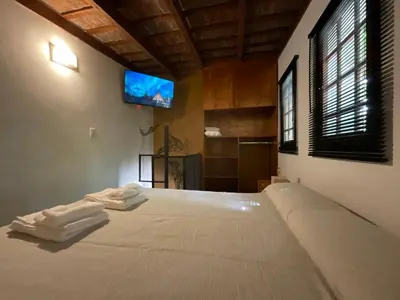 a bedroom with a bed with a tv on the wall at Encantador Duplex cerca de todo in Cordoba