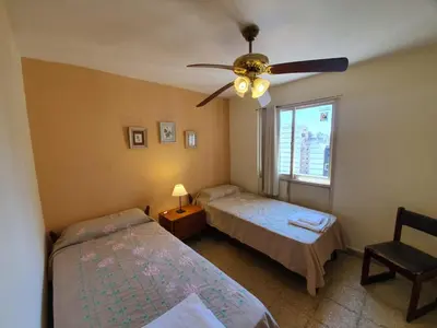 a bedroom with two beds and a ceiling fan at Dpto Cordoba Capital in Cordoba