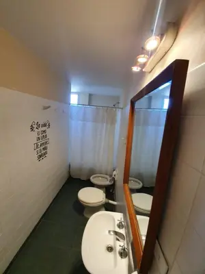 a bathroom with two toilets and a sink and a mirror at Dpto Cordoba Capital in Cordoba