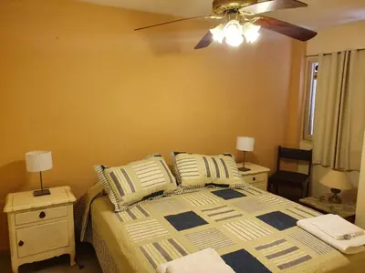 a bedroom with a bed and a ceiling fan at Dpto Cordoba Capital in Cordoba