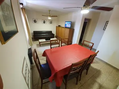 a dining room with a red table and chairs at Dpto Cordoba Capital in Cordoba