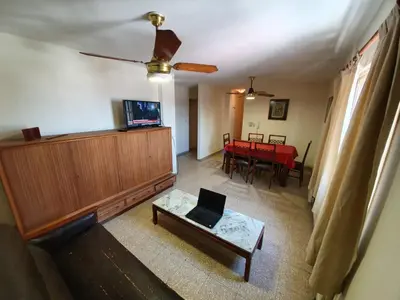 a living room with a table and a laptop on a couch at Dpto Cordoba Capital in Cordoba