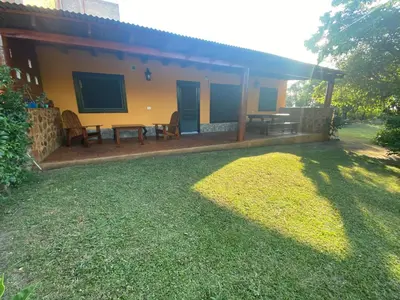 a house with a table and chairs in the yard at Cabaña Emilia in San Javier